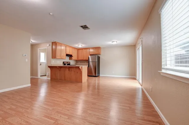 a view of kitchen with refrigerator stove microwave and cabinets