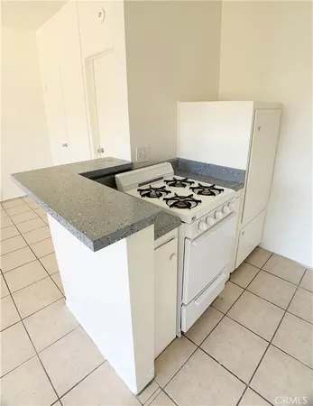 a stove top oven sitting inside of a kitchen
