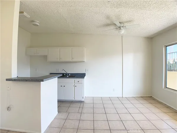 a kitchen with a stove a sink and cabinets