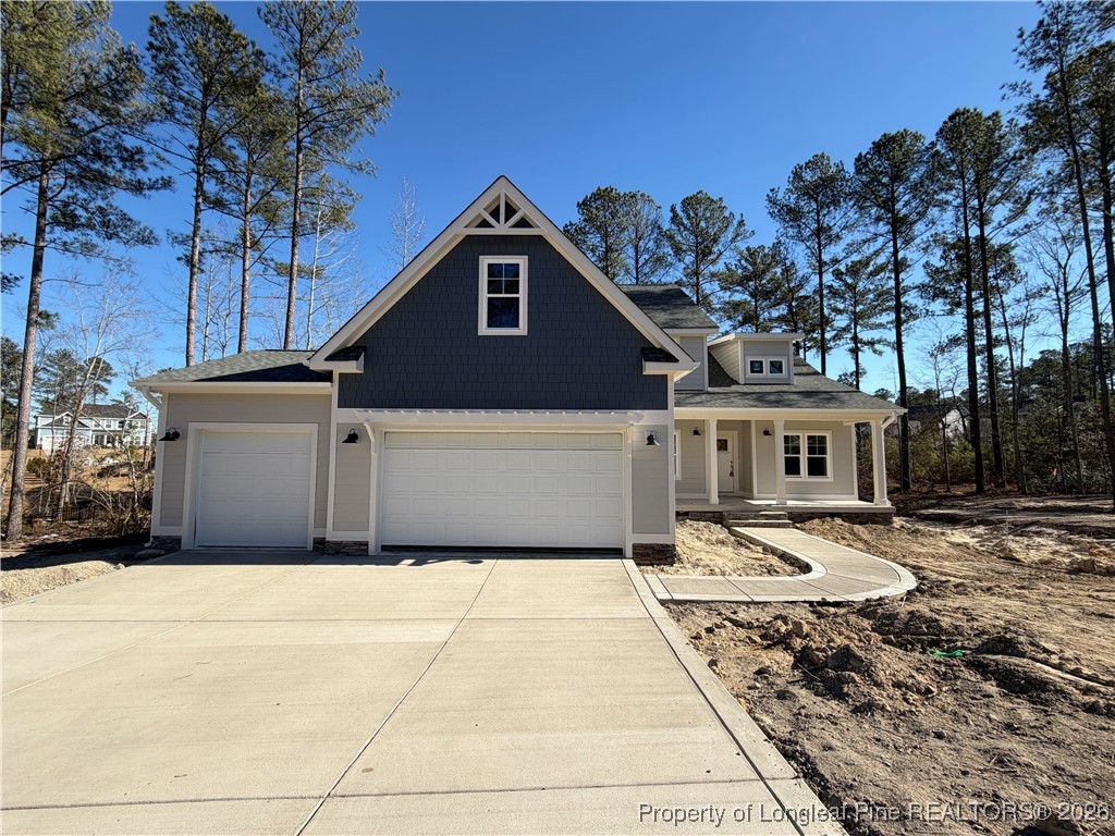 a front view of a house with a yard and parking space