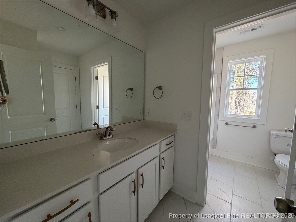 96 Graduate Ct Spring Lake Spring Lake, NC 28390 - Photo 12 of 33 a bathroom with a sink toilet and vanity
