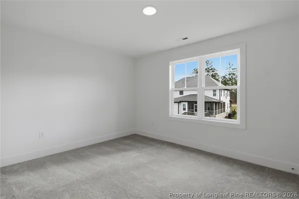 a green building sitting in front of a yard