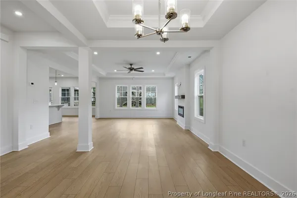 a view of an empty room with a fireplace and a window