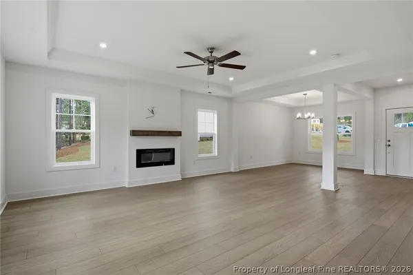 a kitchen with stainless steel appliances a stove a sink a microwave a center island and a window