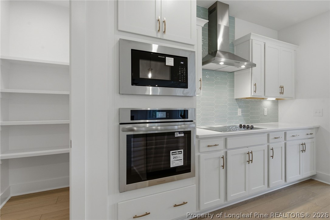 96 Graduate Ct Spring Lake Spring Lake, NC 28390 - Photo 9 of 49 a kitchen with stainless steel appliances granite countertop white cabinets a microwave oven and white cabinets