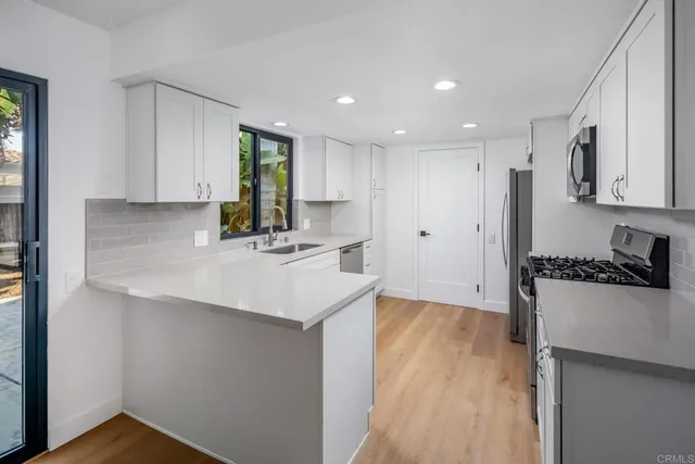 a kitchen with sink attached with living room