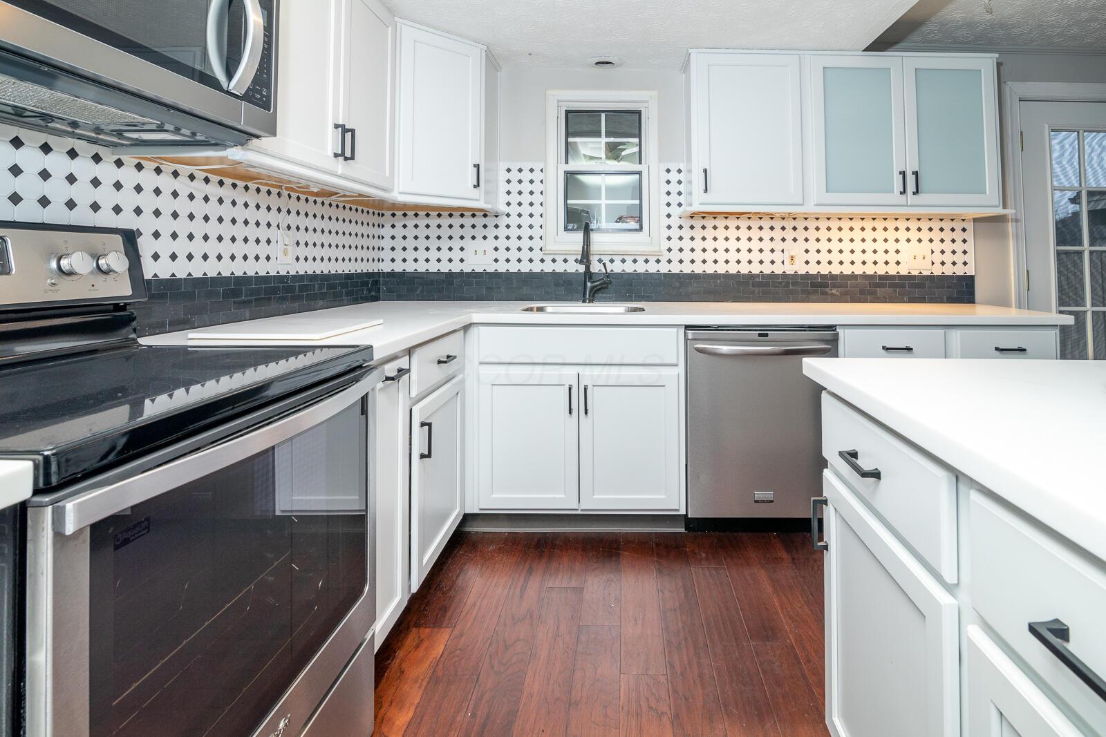 5179 Rittenhouse Square North, Unit 2379 Columbus, OH 43220 - Photo 12 of 32 Tile Backsplash, New Corian Countertops & New Stainless Steel Appliances.