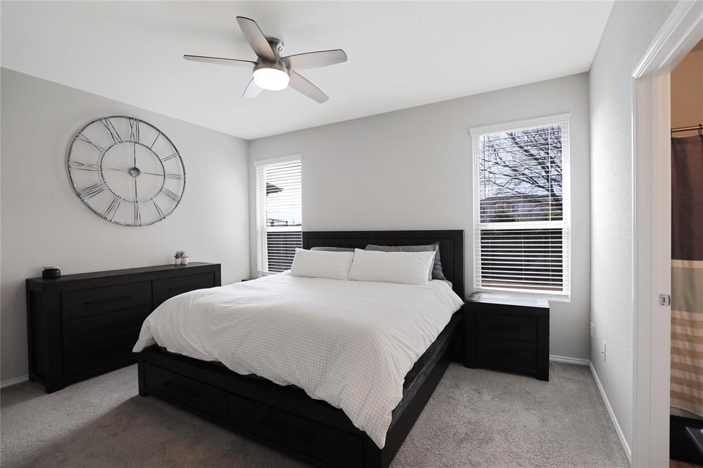 813 Williams Way Van Alstyne, TX 75495 - Photo 16 of 27 a bedroom with a bed and a chandelier