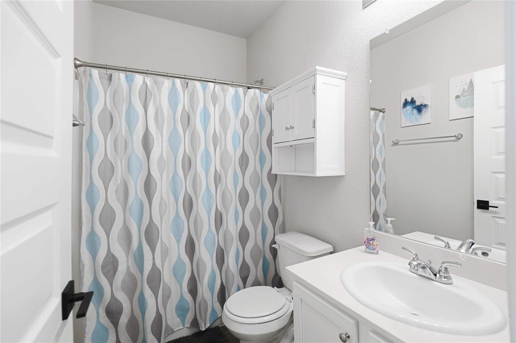 813 Williams Way Van Alstyne, TX 75495 - Photo 20 of 27 a bathroom with a sink toilet and shower
