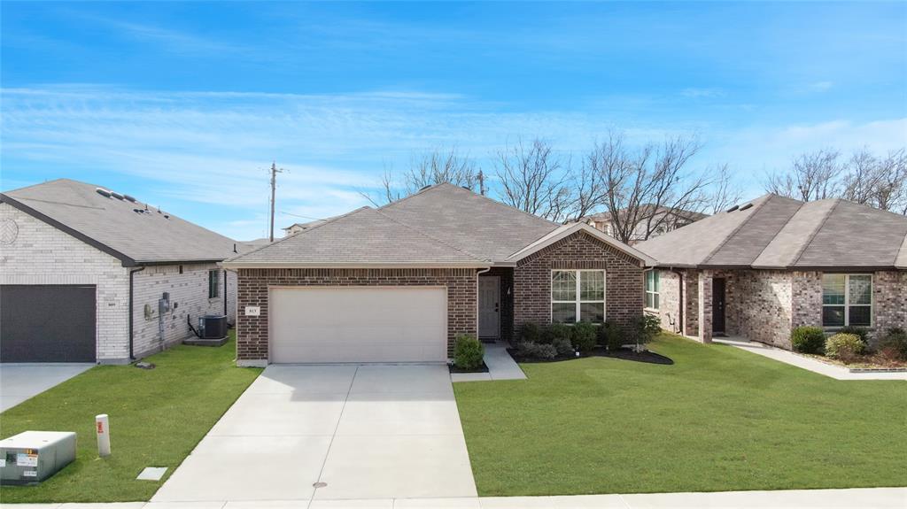 813 Williams Way Van Alstyne, TX 75495 - Photo 4 of 27 a front view of a house with a garden and yard