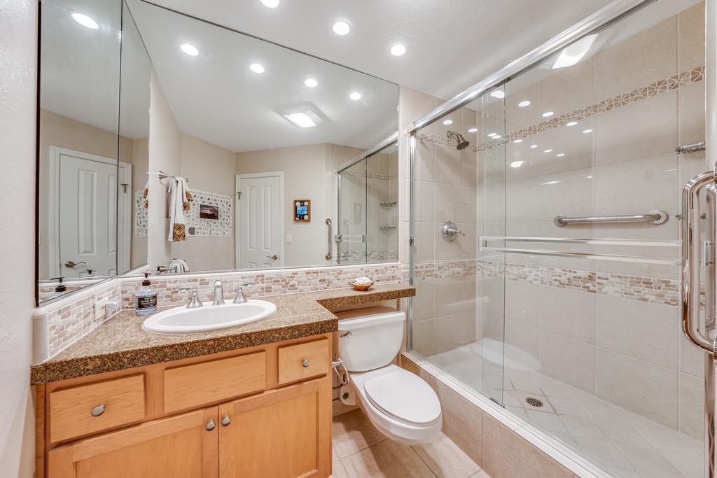 101 Shell Road, Unit 290 Watsonville, CA 95076 - Photo 19 of 26 a bathroom with a shower sink vanity mirror and toilet