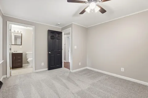 a bathroom with a toilet sink vanity and mirror