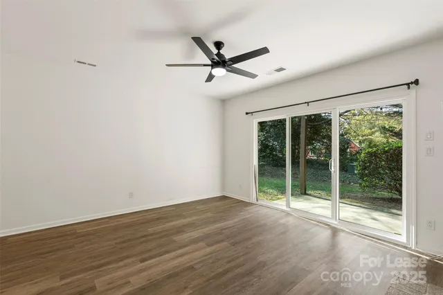 a view of a livingroom with a ceiling fan and window