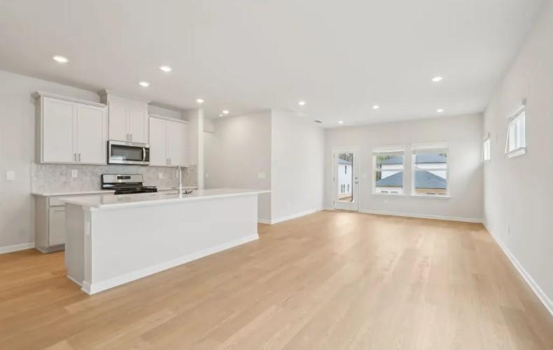 2850 Aralynn Way College Park, GA 30337 - Photo 4 of 9 a view of kitchen with stainless steel appliances granite countertop a stove top oven a sink and a microwave