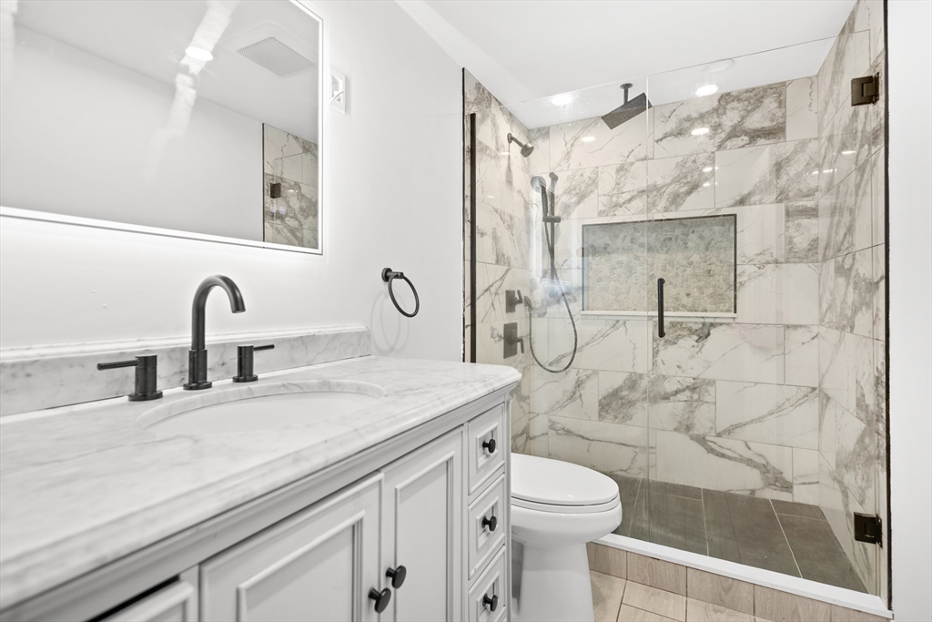 27 Ward Well Road Canton, MA 02021 - Photo 4 of 33 a bathroom with a sink a toilet and shower
