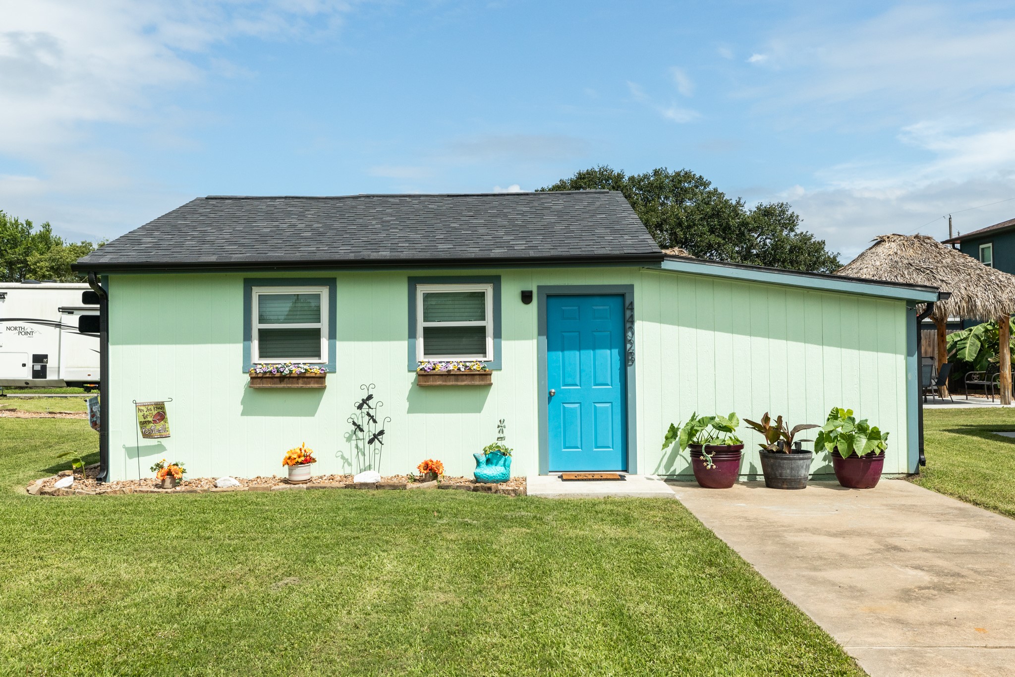 4402 Zelsky Road Freeport, TX 77541 - Photo 11 of 37 a front view of a house with a garden and plants