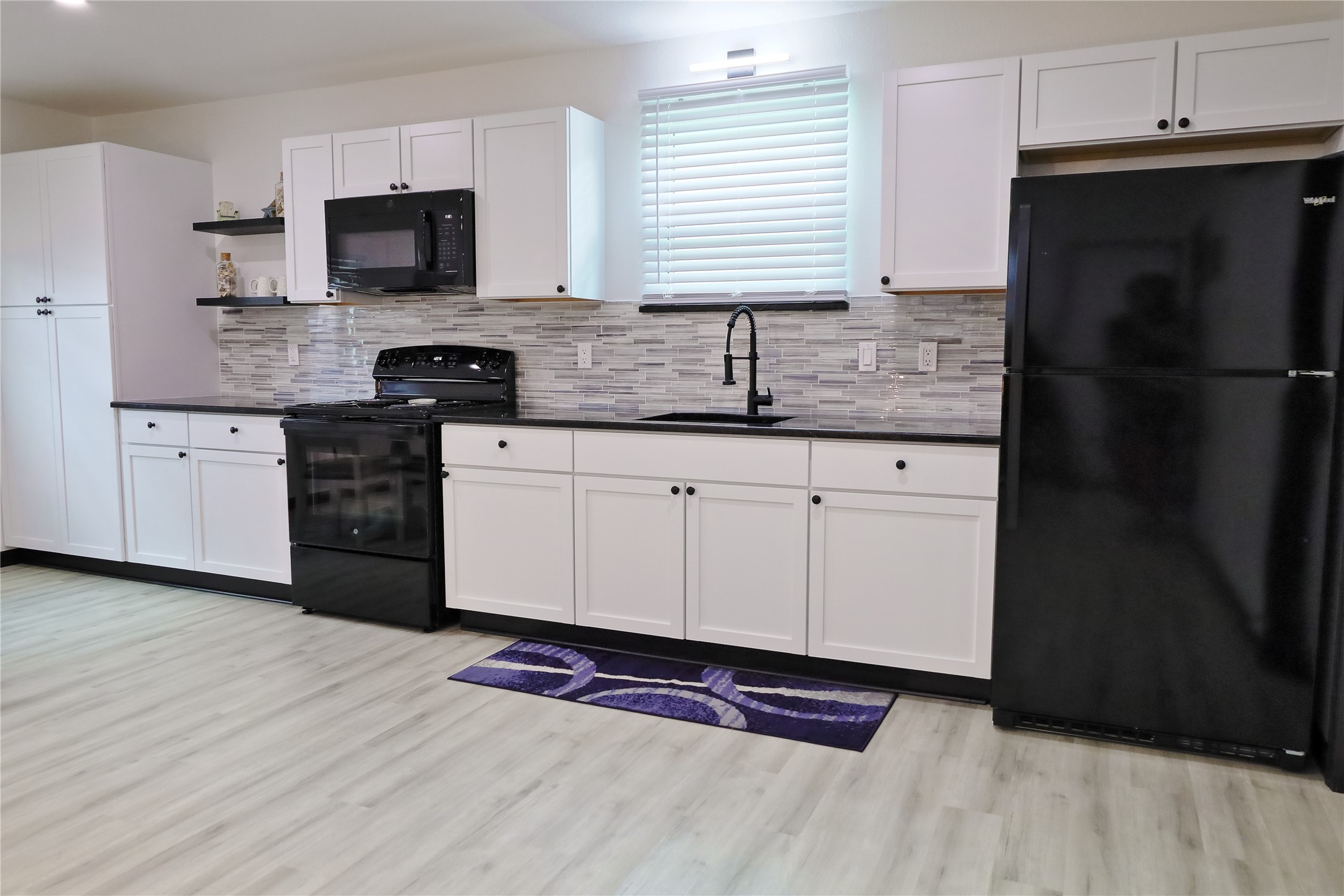 4402 Zelsky Road Freeport, TX 77541 - Photo 16 of 37 a kitchen with stainless steel appliances a refrigerator sink and microwave
