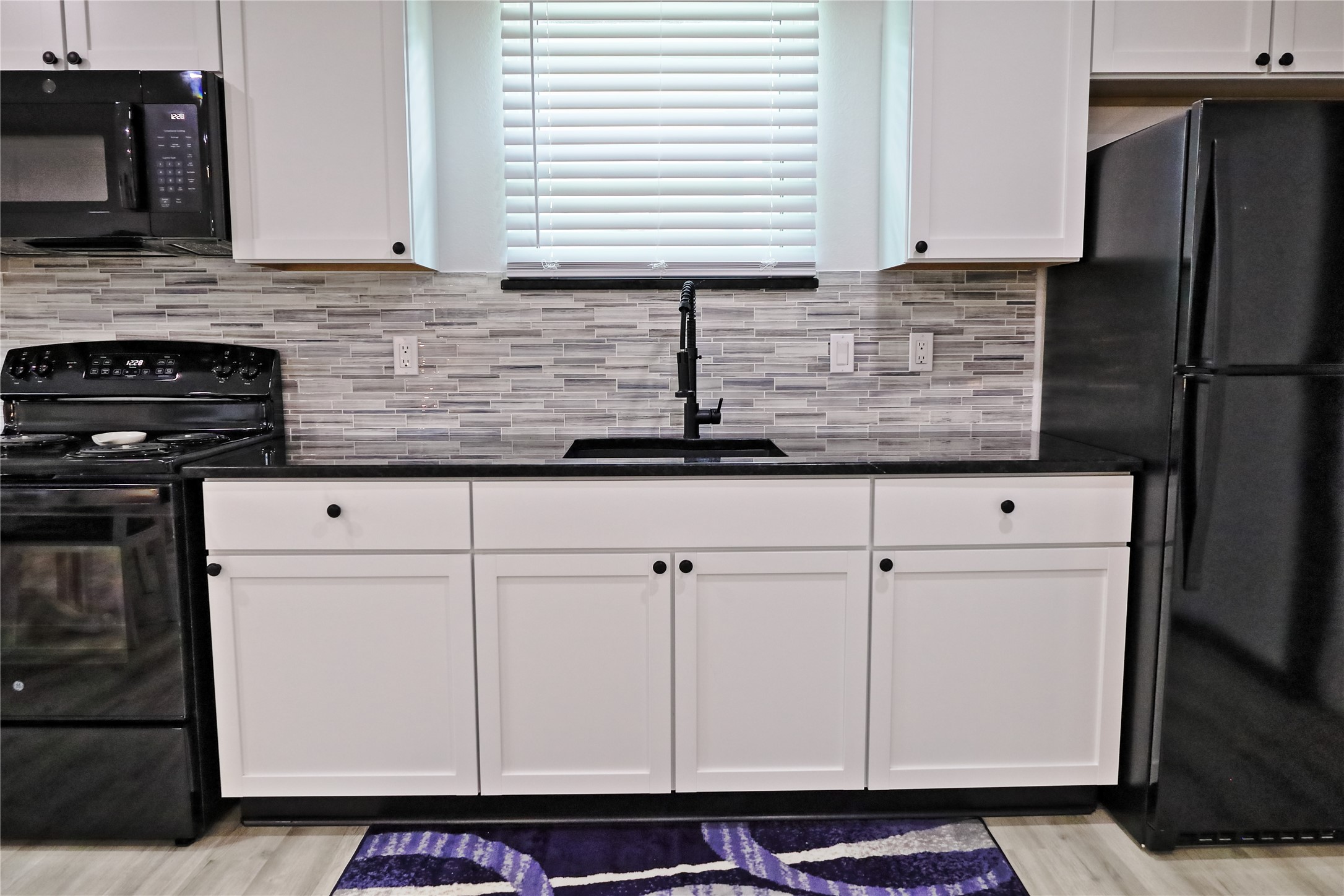 4402 Zelsky Road Freeport, TX 77541 - Photo 17 of 37 a kitchen with stainless steel appliances granite countertop a sink stove and refrigerator