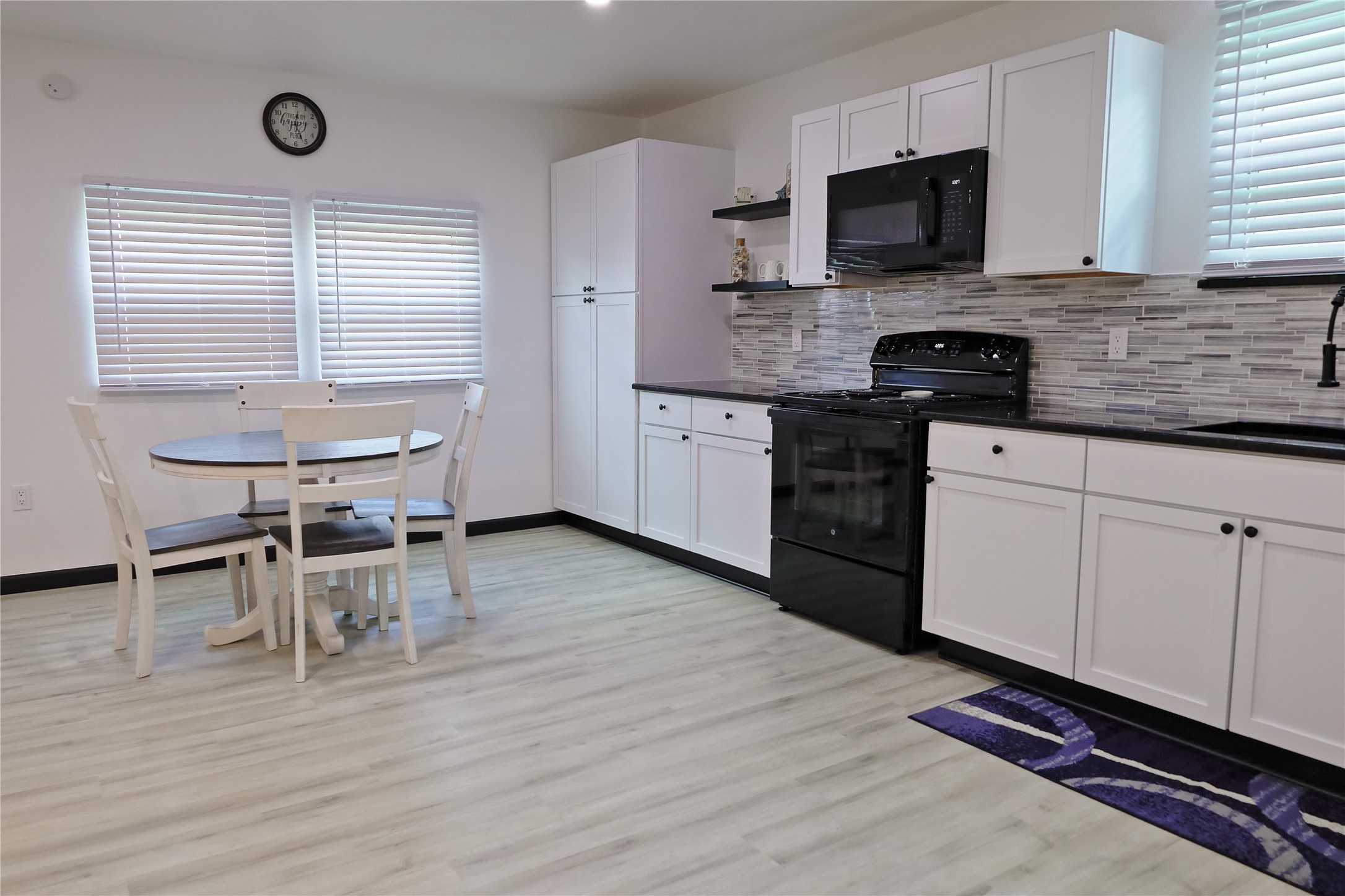 4402 Zelsky Road Freeport, TX 77541 - Photo 37 of 37 a kitchen with stainless steel appliances a stove a sink a microwave a refrigerator and cabinets