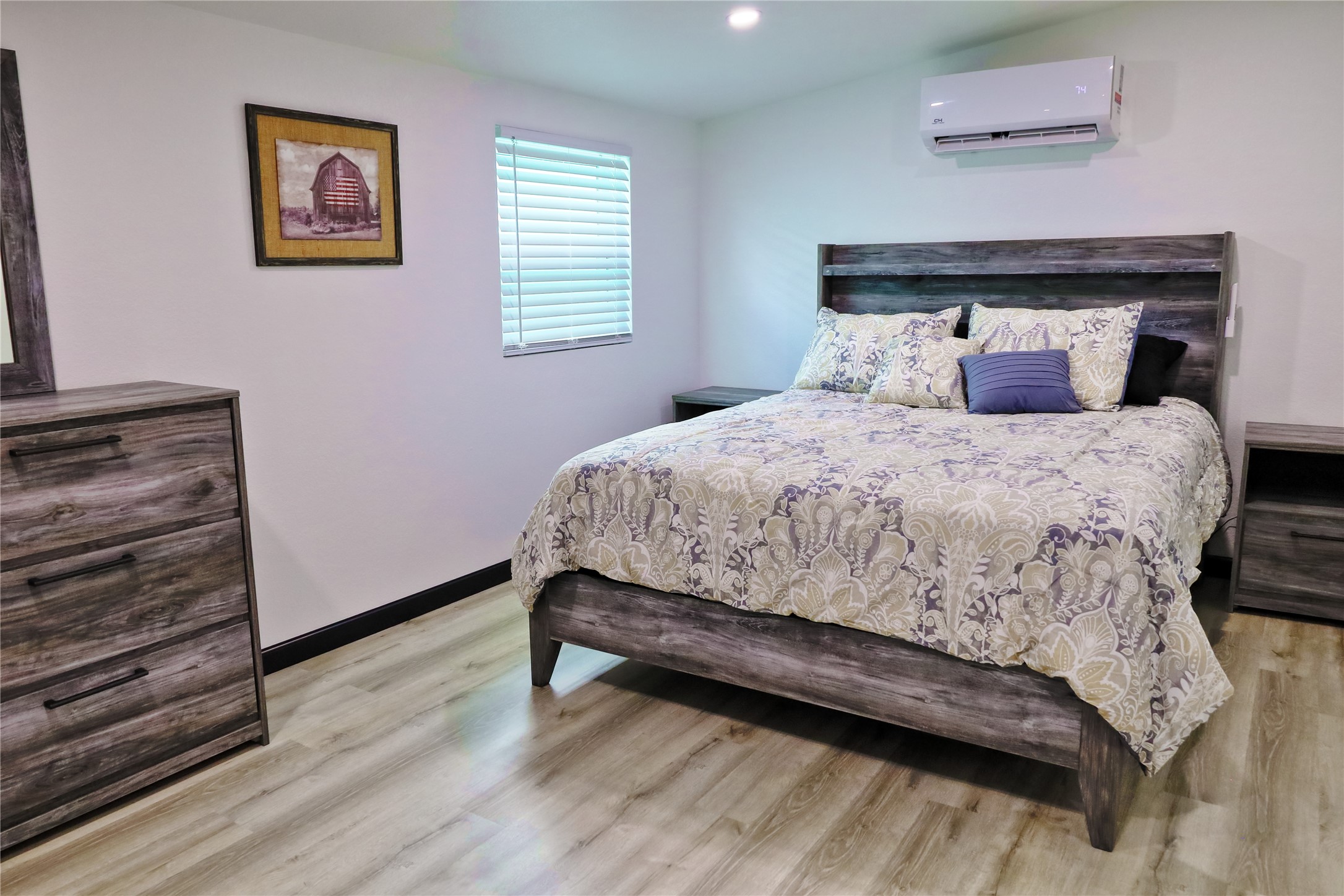 4402 Zelsky Road Freeport, TX 77541 - Photo 7 of 37 a bedroom with a bed and wooden floor
