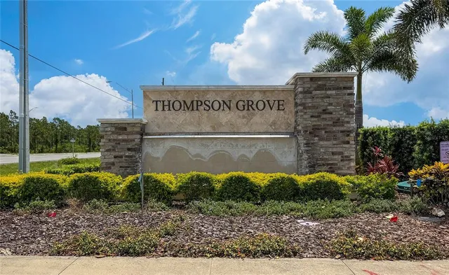 a sign board with a building in the background