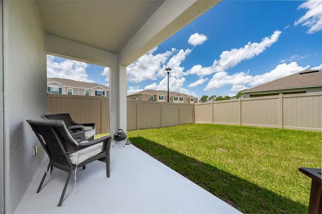 a view of a house with swimming pool and a yard