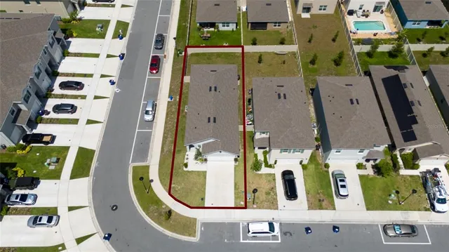 an aerial view of residential house with outdoor space and parking