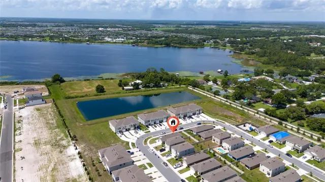 an aerial view of a house with a garden and lake view