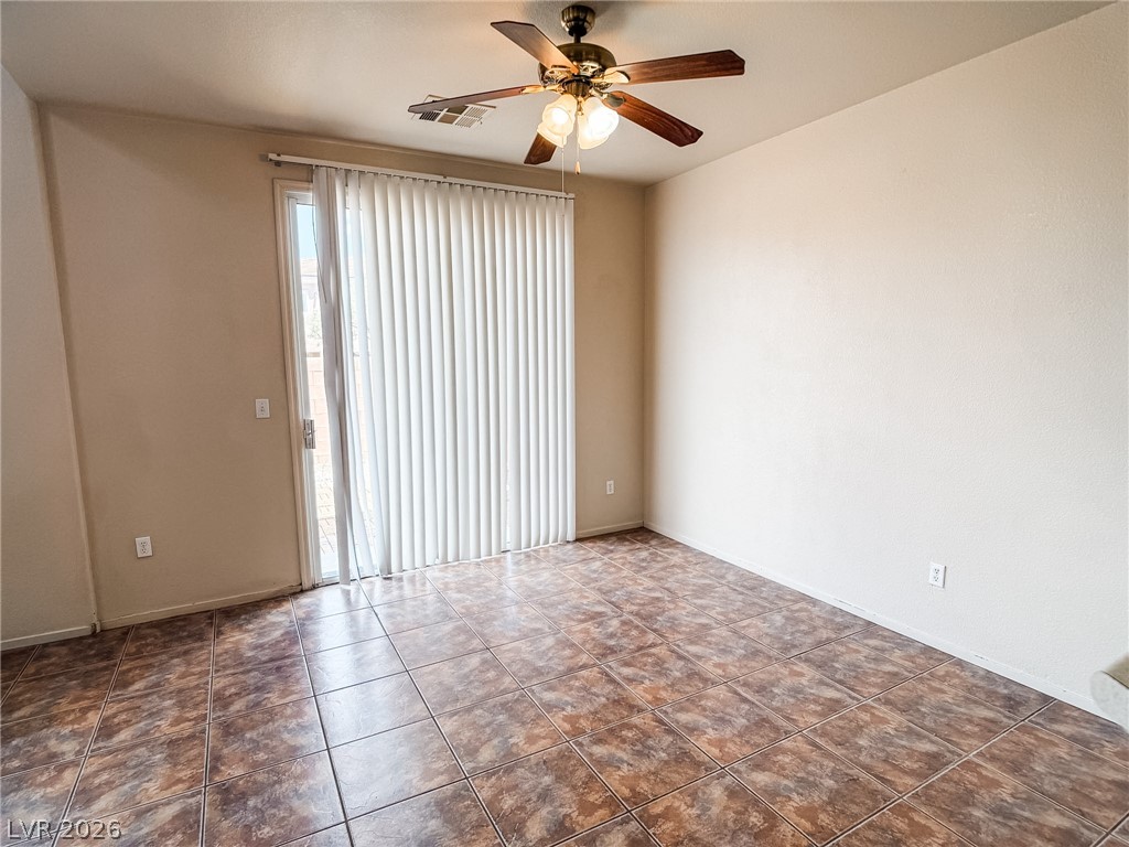 228 Positive Point Street Henderson, NV 89012 - Photo 11 of 27 Natural light streams into this versatile living area through a glass sliding door.