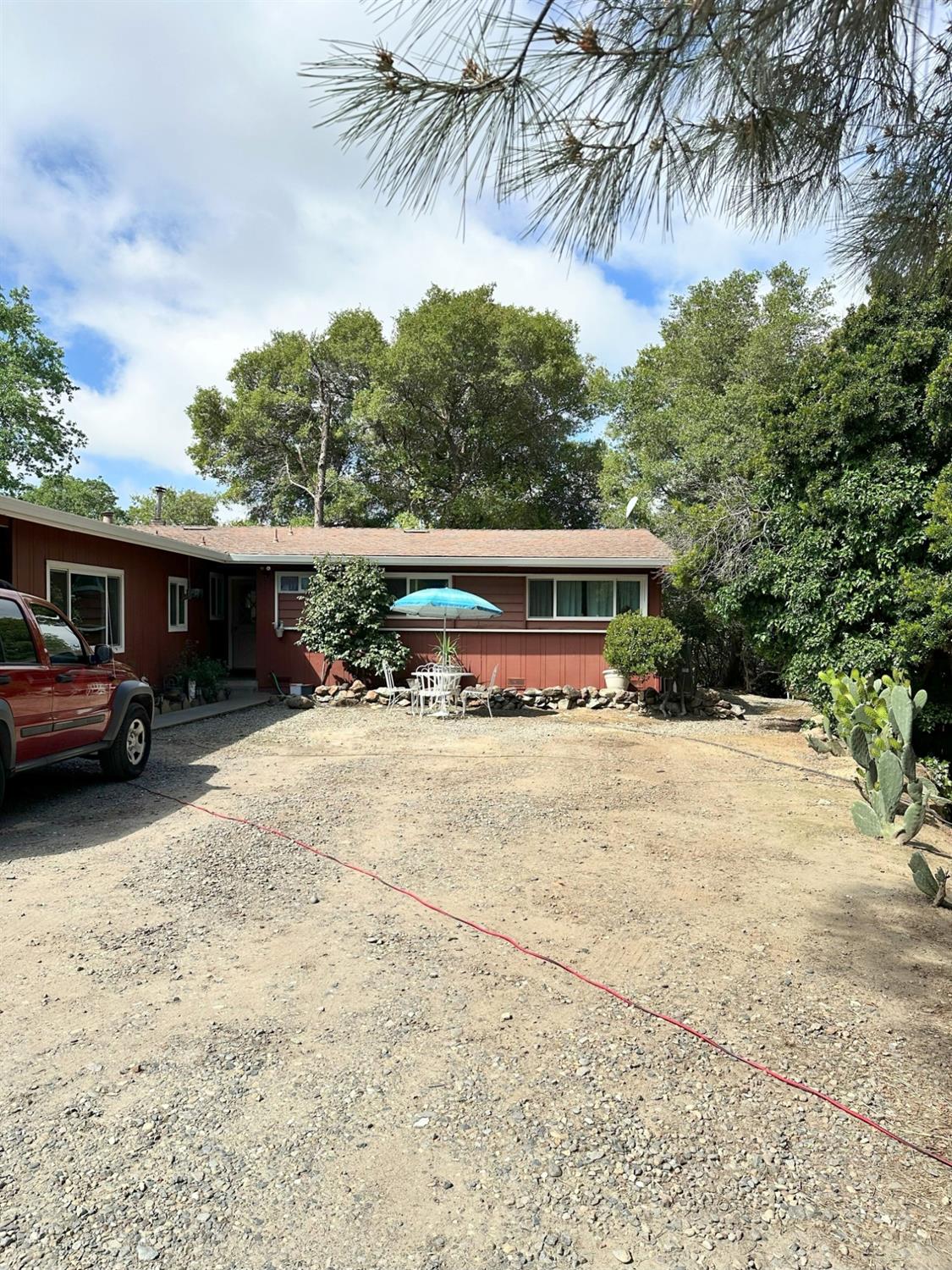 a view of house with outdoor space and car parked
