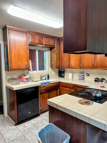 a kitchen with a sink cabinets and window