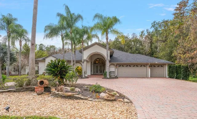 a front view of a house with a garden and potted plants