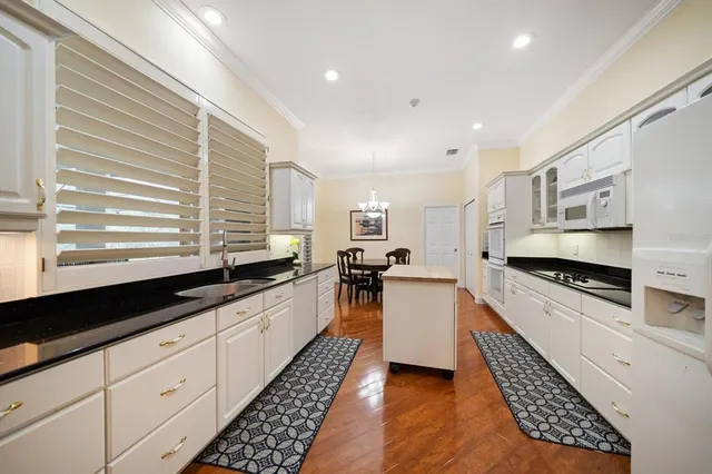 a kitchen with stainless steel appliances granite countertop a sink and cabinets