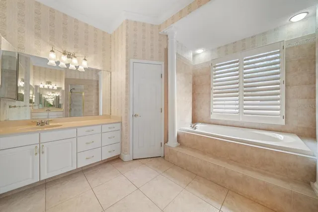 a spacious bathroom with a tub shower and sink
