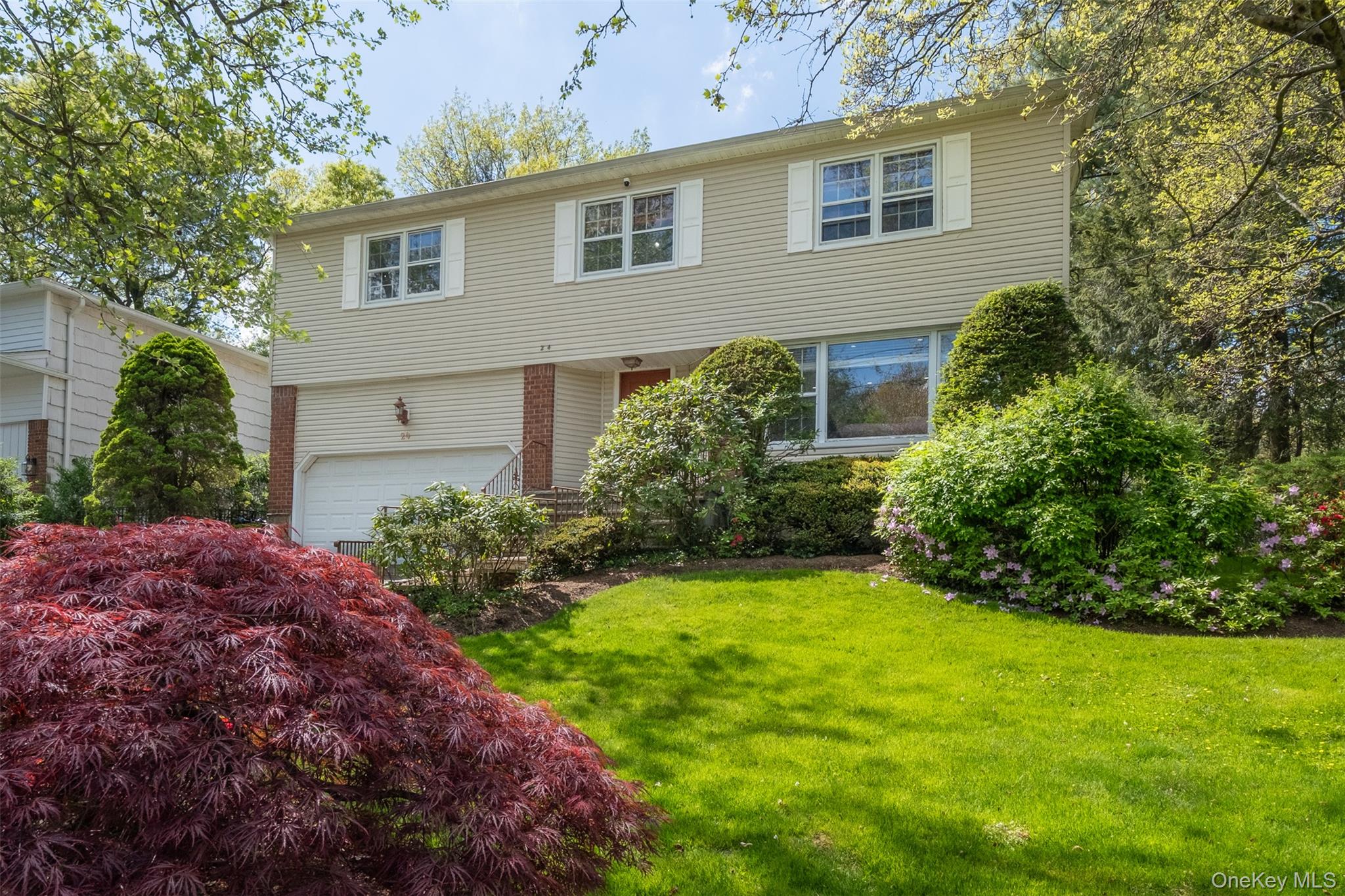 24 Sheldrake Place New Rochelle, NY 10804 - Photo 2 of 26 View of front of home featuring a front yard and an attached garage