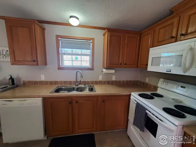 a kitchen with a sink stove and microwave