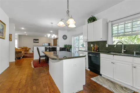 a kitchen with stainless steel appliances kitchen island granite countertop a sink and cabinets