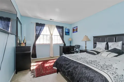 a bedroom with a bed and a chair in it