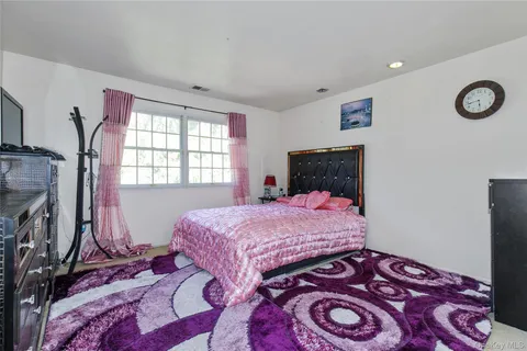 a bathroom with a granite countertop sink a toilet a mirror and shower