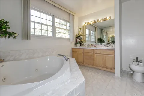 a bathroom with a sink a toilet a shower and a mirror