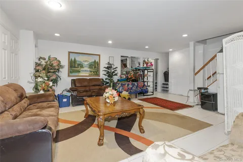 a living room with furniture gym equipment and a flat screen tv