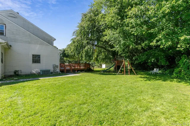 a view of a wooden deck with a big yard