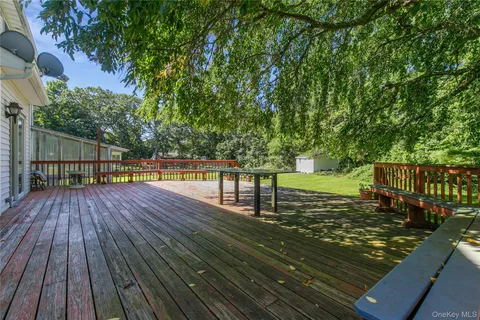a view of green field with trees in the background