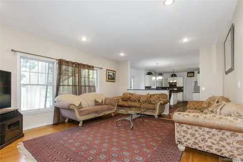 a living room with furniture a rug and a window