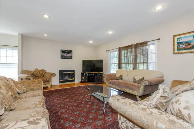 a living room with furniture large window and a flat screen tv