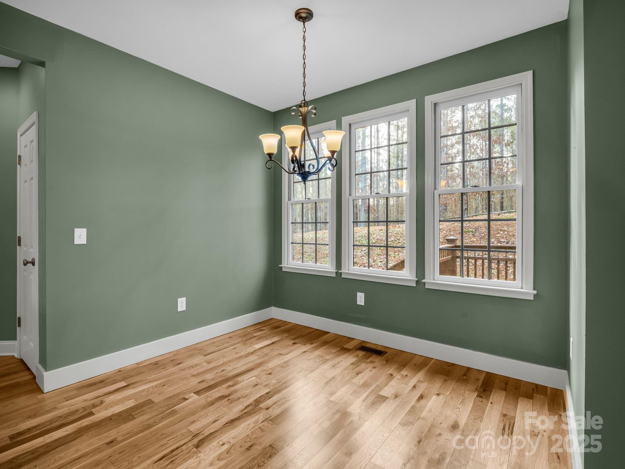 351 East Rambling Creek Drive Tryon, NC 28782 - Photo 14 of 48 a view of a room with window wooden floor and chandelier