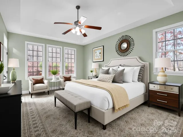 a spacious bedroom with a bed and windows