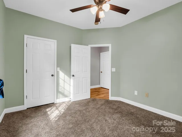 a view of a livingroom with a chandelier fan