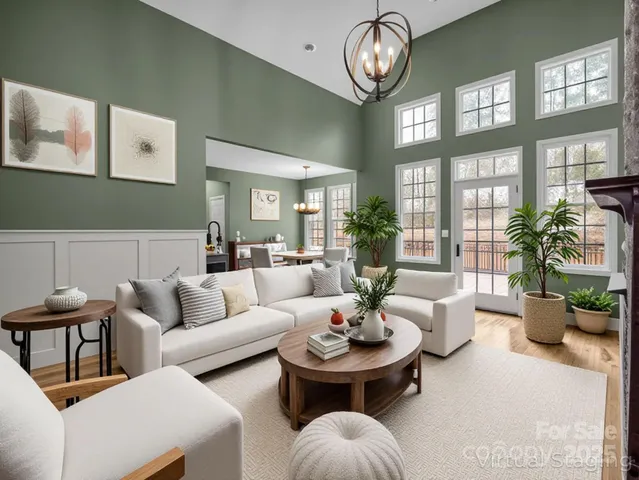 a living room with furniture flower and a large window
