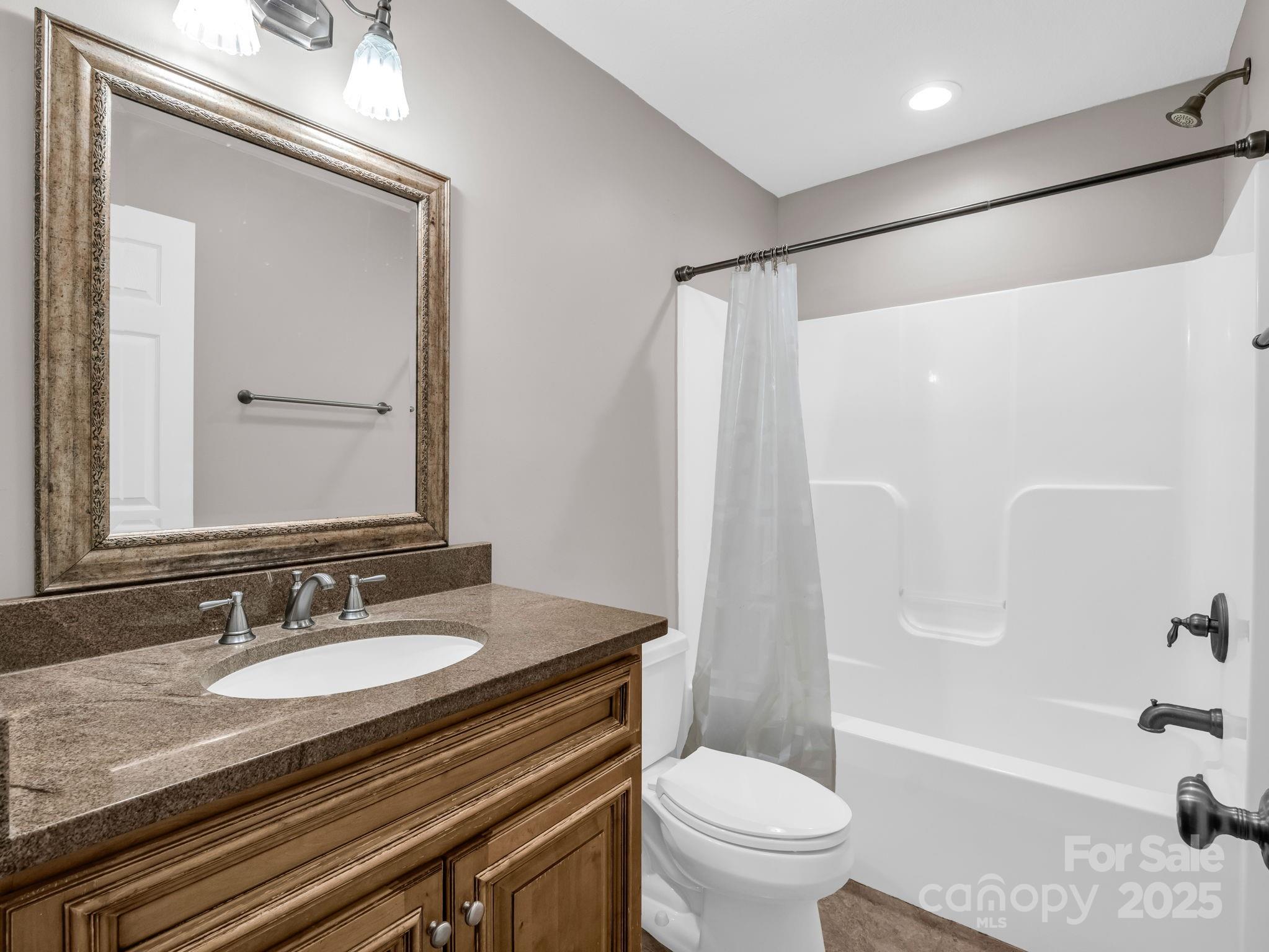 351 East Rambling Creek Drive Tryon, NC 28782 - Photo 35 of 48 a bathroom with a granite countertop sink toilet and shower